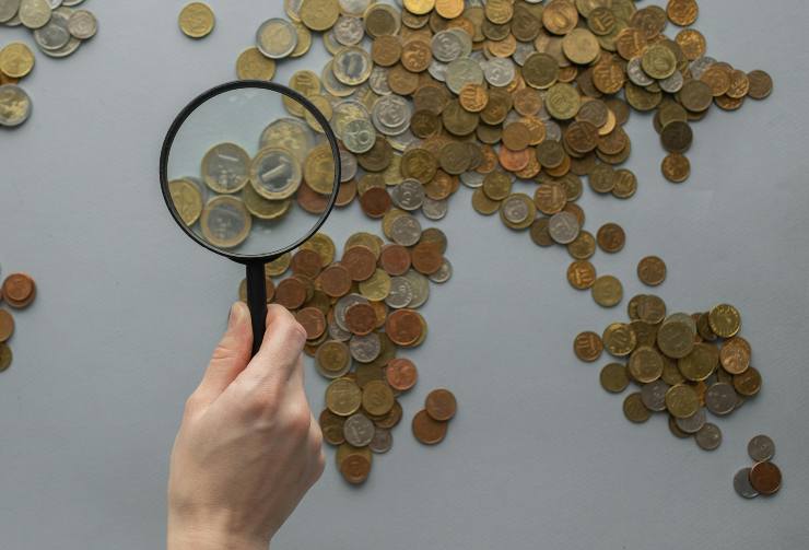 monete e lente di ingrandimento